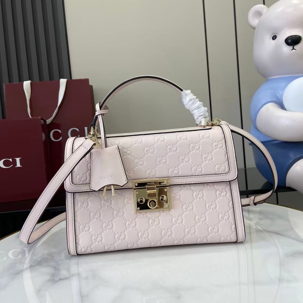 Chanel 25 Hobo bag grey coated canvas and antique gold-tone hardware + Hermès Birkin 25 handbag Beige Marfa Togo leather + Gucci Padlock small top handle bag embossed pink GG leather
